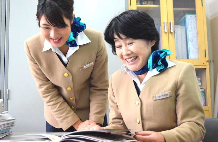 Two Japanese woman happily working in an office