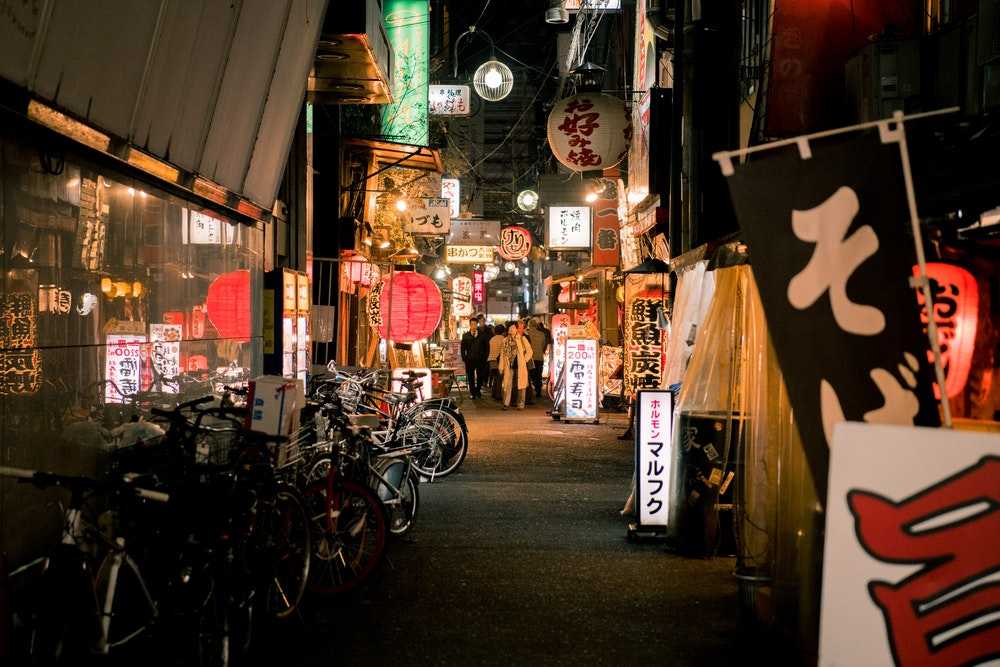 bicycles parked near japanese store during night time 2070028